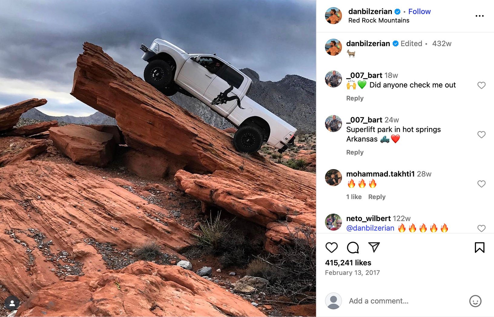 White truck climbing steep red rock formation in the desert