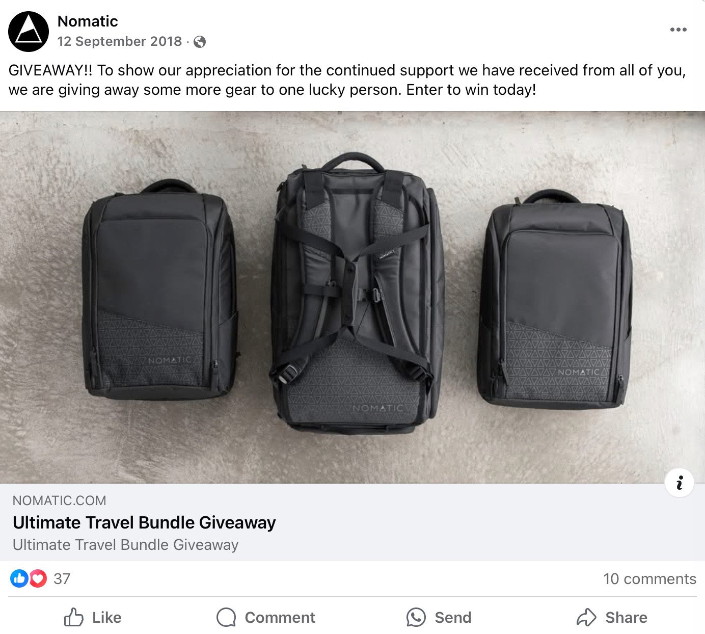 Three Nomatic travel backpacks displayed side by side on concrete background