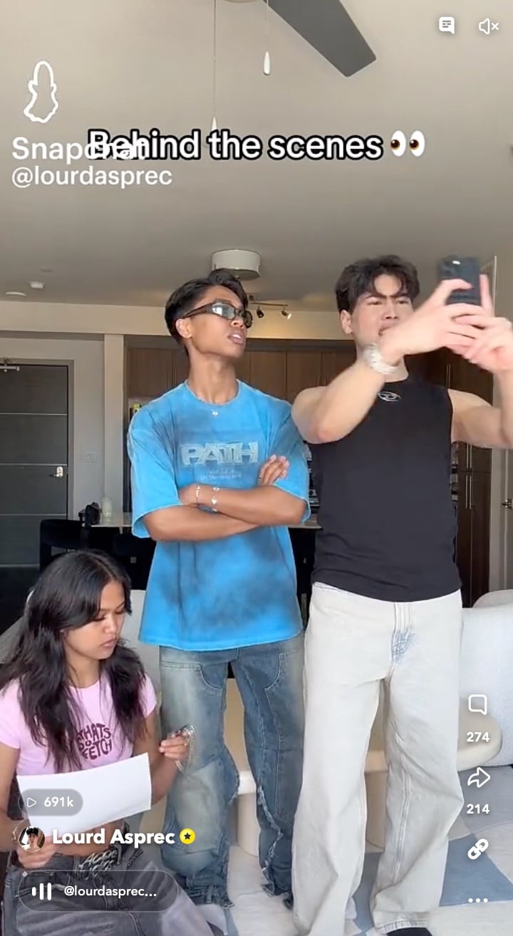 Behind-the-scenes moment showing three creators filming content in a modern apartment