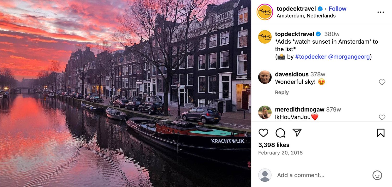 A canal in Amsterdam at sunset, with deep pink clouds glowing in the sky and canal houses reflecting in the water