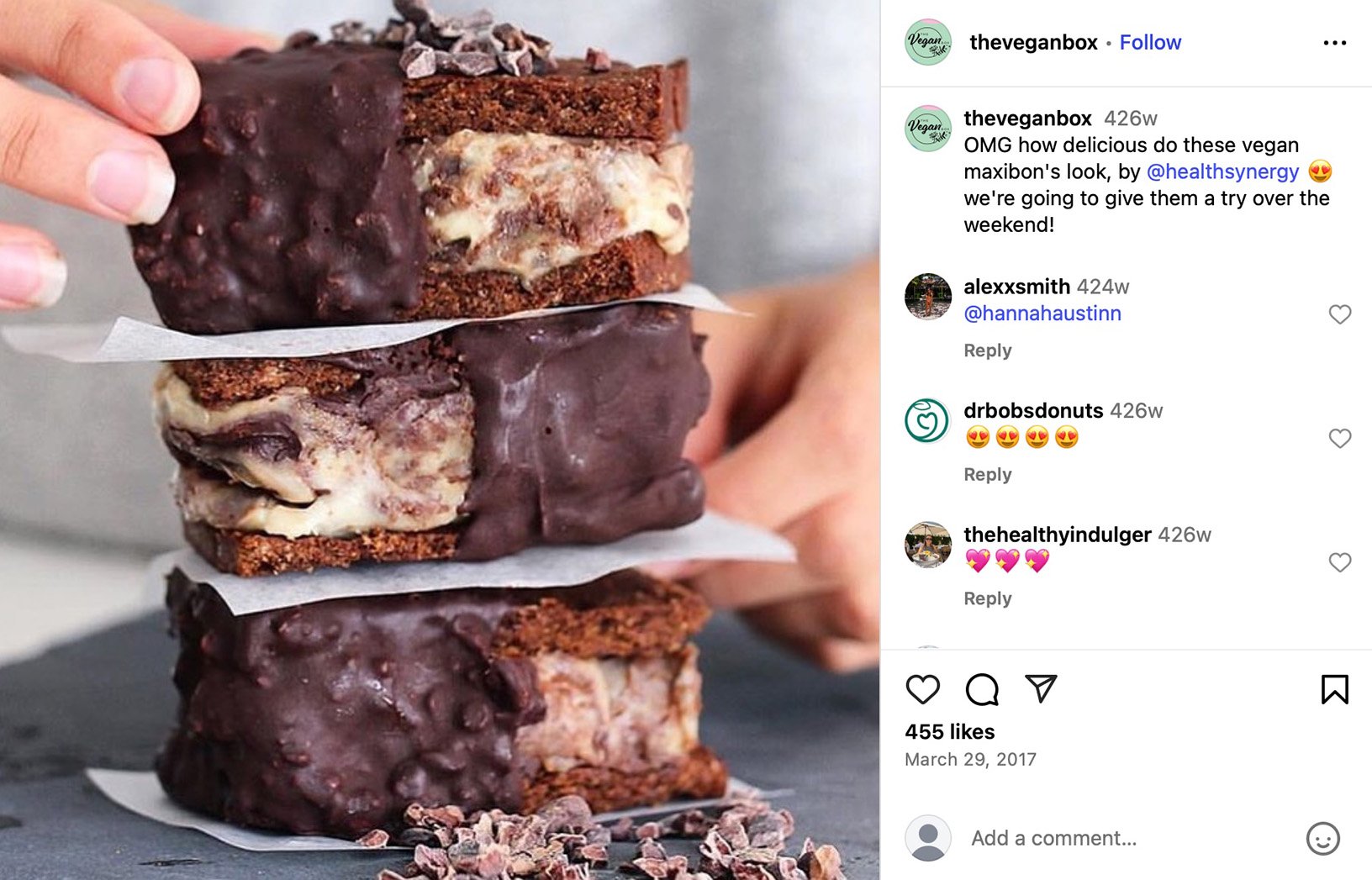 Three stacked vegan ice cream cookie sandwiches covered in chocolate