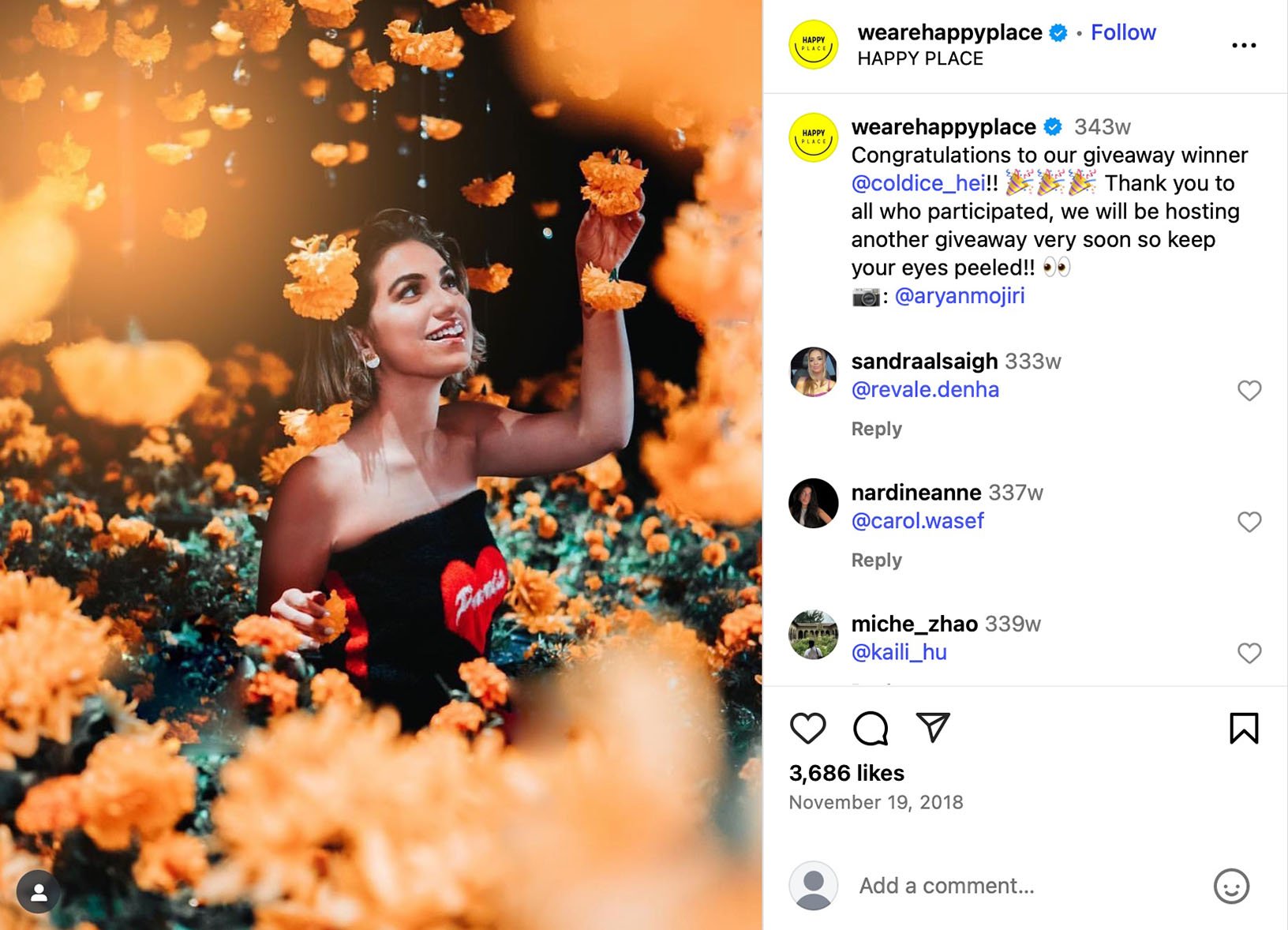 Giveaway winner Eliana holding a gift card in front of the Chapter at Eugene signage