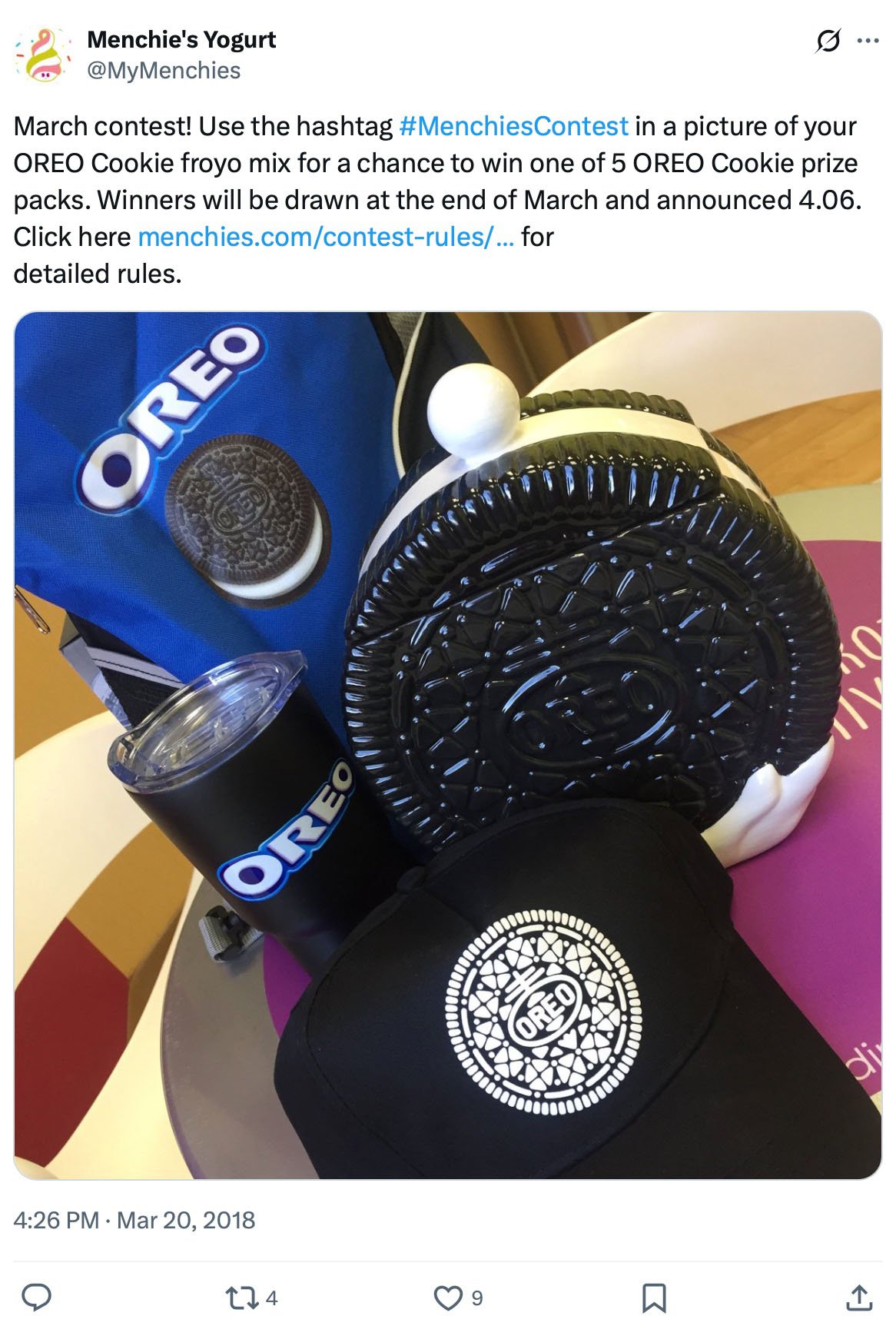 Oreo-themed prize items including a cookie-shaped pillow, hat, tumbler, and bag on display for the Menchie’s March contest